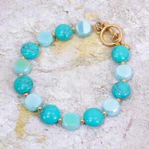 Turquoise color bracelet with turquoise stones, glass beads and small gold beads